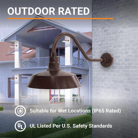 Outdoor Gooseneck Barn Light Fixture With Satin Black Finish, 14 Inch Shade And 22 Inch Extension Arm, mounted on wall with house in view.