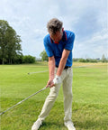 Golfer using Golf Belt Laser And Rod Mount For Swing Training And Putting Alignment Securely Attaches To Back Chest Or Hip outdoors