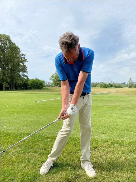 Golfer using Golf Belt Laser And Rod Mount For Swing Training And Putting Alignment Securely Attaches To Back Chest Or Hip outdoors