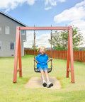 Child swinging on a garden swing set under a blue sky