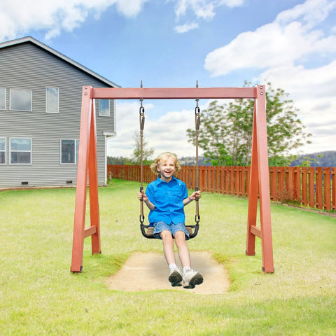 Child swinging on a garden swing set under a blue sky