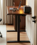 Top Shelf Electric Standing Desk With Ultra Wide Worktop Effortless Height Adjustment Hidden Wire Basket Natural Walnut Finish close-up of worktop and base