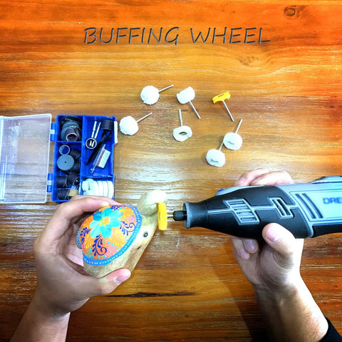 Person using a rotary tool with a Cashmere Polishing Buffing Wheel Set For Rotary Tool One Eighth Inch Shank on a painted wooden object.