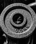 Close-up of 8 Pack Cast Iron Weight Plates 1.1 Lbs Each, 1 Inch Hole For Home Gym, solid texture and detailed design
