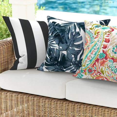 Two Pack Waterproof Outdoor Throw Pillows With Inserts 18x18 Square Cushions For Patio Deck Garden Or Home Furniture Cabana Black All Weather Decor For Sofa Bench And Lounge, shown on a wicker sofa.