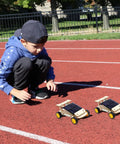 Child playing with two solar-powered cars from Hands On Solar And Wind STEM Kits For Kids Aged 8 9 10 11 12 Build A Solar Car Plane Wind Powered Car And Electric Fan This Cool And Fun Science Set For Family Bonding And Real World Learning For Boys And Girls Gift on a track