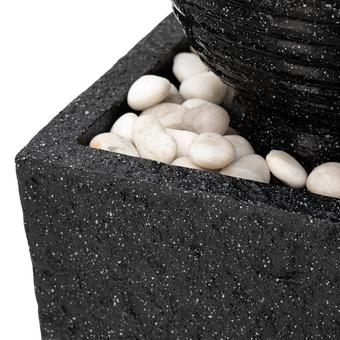 Close-up of outdoor LED light water fountain with submersible pump black pedestal modern sphere floor fountain for patio and garden decor.