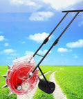 Manual Seed Spreader Hand Push Garden Seeder Row Planter with Six Seed Settings Wheels on a grassy path