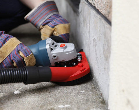 Dust Shroud for Angle Grinders 115mm 125mm With Soft Brush Ring Dust Guard in use on a wall corner for dust control