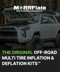 SUV with hood open in forest equipped with off-road multi tire inflation deflation kit