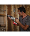 Man using a Compact 20V Max Cordless Reciprocating Saw With Variable Speed And Quick Release Blades on wood framing.