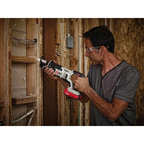Man using a Compact 20V Max Cordless Reciprocating Saw With Variable Speed And Quick Release Blades on wood framing.