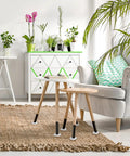 Living room with small wooden tables, 24 Pack Spiked Caster Cups For Furniture Protectors Clear Plastic Round And Square Cups visible on legs, on a woven rug.