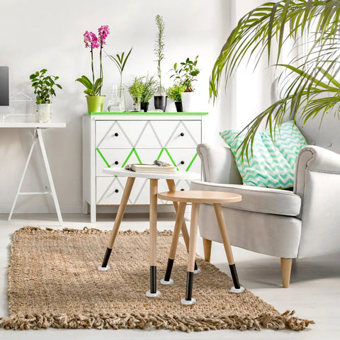 Living room with small wooden tables, 24 Pack Spiked Caster Cups For Furniture Protectors Clear Plastic Round And Square Cups visible on legs, on a woven rug.