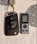 Pocket Size Laser Distance Meter 164 Ft Range USB Rechargeable next to a car key, showcasing compact design and easy portability.