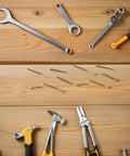 100 Piece M6 Zinc Plated Furniture Bolts And Nuts Kit with tools on wooden surface