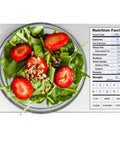 Meal-Prep Go-To Food Scale With Built-In Nutrition Calculator weighing salad, 11 lb capacity, silver kitchen scale visible