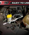 Close-up of Beast 110 Piece Metric Tap And Die Set tool in use for threading bolts in engine area for quick repairs.