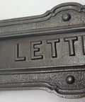 Neo Classical Cast Iron Mailbox With Swinging Letter Slot Door Wall Mounted Vintage Antique Postal Box Old School Charm, Ornate Garlands And Floral Accents, Reproduction Of 1900 Original With Weathered Iron Finish, close-up of letter slot detail