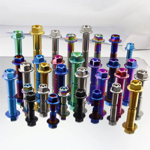 Colorful titanium flanged hex head bolts arranged on a reflective surface, showcasing various sizes and colors of aerospace-grade fasteners.