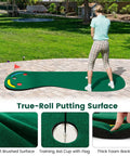 Person practicing on Par 3 Putting Green Mat 10 Foot By 3 Foot With 3 Cups Flag And Hole Covers in backyard