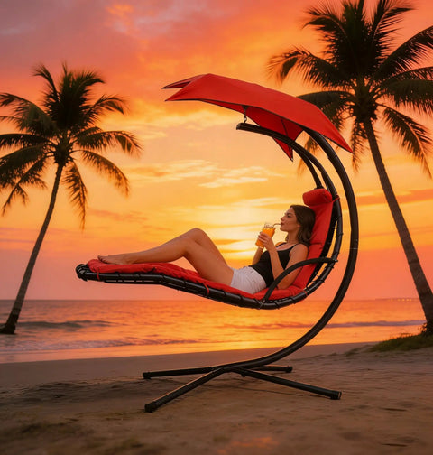 Woman relaxing in Freestanding Arc Stand Hanging Chaise Lounge Swing Chair With Curved Steel Frame against sunset by the beach.