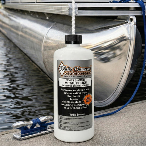 Bottle of Metal Polish With Long Lasting Sealant Cleaner Polisher Protectant All In One on dock beside metal boat
