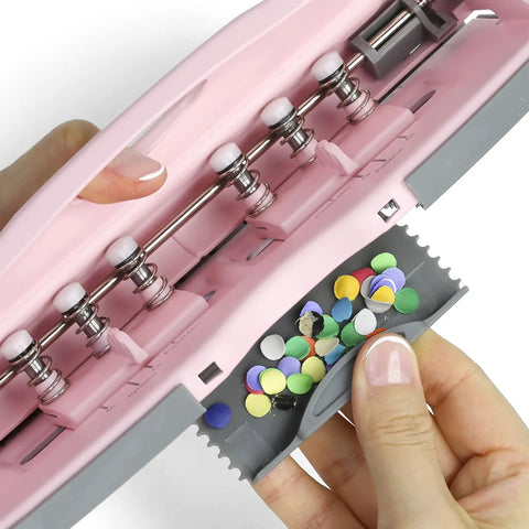 Close-up of pink adjustable 6-hole punch for planners and binders with 8 sheet capacity, showing scrap caddy.