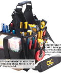 Large Electrical And Maintenance Tool Carrier With 22 Pockets, 8.75 Inch By 6.5 Inch Multi Compartment Tray, Heavy Duty Black Tool Bag For Electricians, Maintenance Pros, And DIY Enthusiasts On The Go. Black tool bag with padded handle and shoulder strap, filled with hand tools.