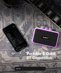 Compact 5W Guitar Amp For On The Go With Dual Speakers Bluetooth Wireless Connectivity Rechargeable Battery Clean And Overdrive Modes Gain Tone And Volume Controls Headphone Jack Ideal For Practice And Small Gigs Purple next to smartphone on rug