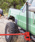 Green truck lifted by Heavy Duty Workhorse 3 Ton Off Road Ratcheting Farm Jack With 6600 Lb Capacity 33 Inch Floor Bumper Lift Jack