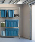 31 Gallon Storage Totes 8 Pack Built Like A Tank Heavy Duty Stackable Bins With Snap On Lids And Easy Grip Handles Eco Friendly Utility Tubs Made In USA in navy on garage shelving.