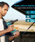 A man operating a Heavy Duty Half Inch Brushless Impact Wrench with dual lithium battery in an outdoor setting.