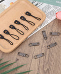 Detachable Metal Zipper Pull Replacement Kit With Six Heads And Six Extension Cords displayed on a wooden tray