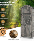 Outdoor Wooden Storage Shed With Tall Vertical Tool Cabinet Folding Table And Removable Shelves For Your Patio Deck Backyard And Lawn Grey Finish 30x20x70 Inches in forest setting