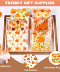 Fall Treat Bags 200 Pack, 4x4 Self Sealing Cellophane Bags filled with fall-themed cookies and candies, perfect for autumn decor.