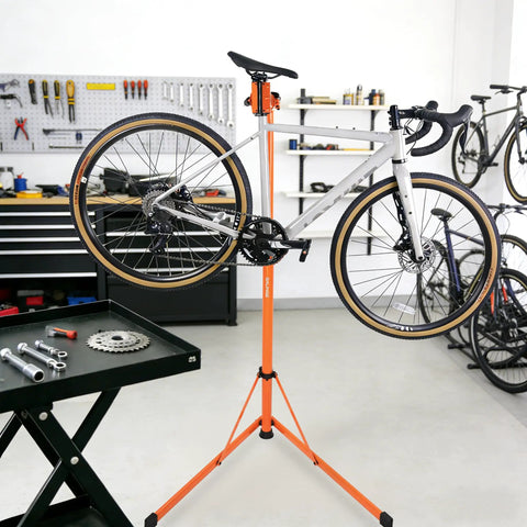 Heavy Duty E Bike Repair Stand Portable Foldable Workstand With 176 Lb Capacity in a workshop, holding a bicycle