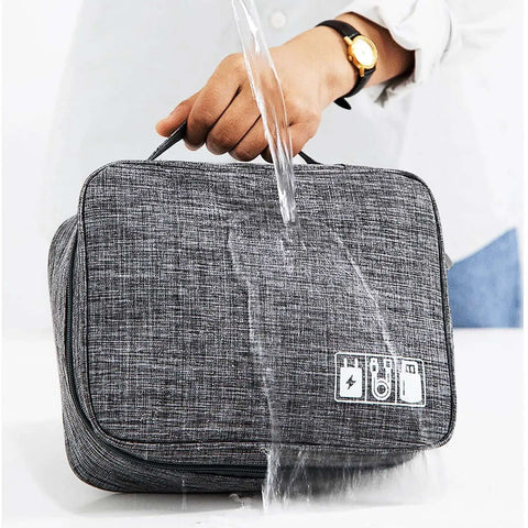 Hella Organized Travel Case For Small Electronics And Usb Charging Gear Including Phone Cables Mouse Sd Cards Power Bank Earphone Bag with water splashing on grey fabric.