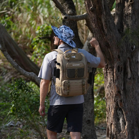 Person wearing Fishing Tackle Backpack With Rod Holder And Four Tackle Boxes, 40/26L Capacity, Water-Resistant, Khaki, in outdoor setting.
