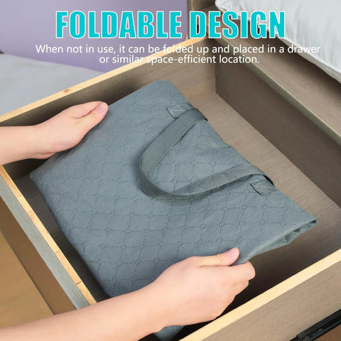 Person placing folded Roomy 105L Extra Large Storage Bag For Blankets Bedding And Clothes 3 Pack With 4 Handles into wooden drawer