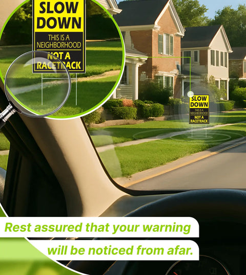 View from inside a car of a yellow "Slow Down This is a Neighborhood Not a Racetrack" sign on a street with houses.