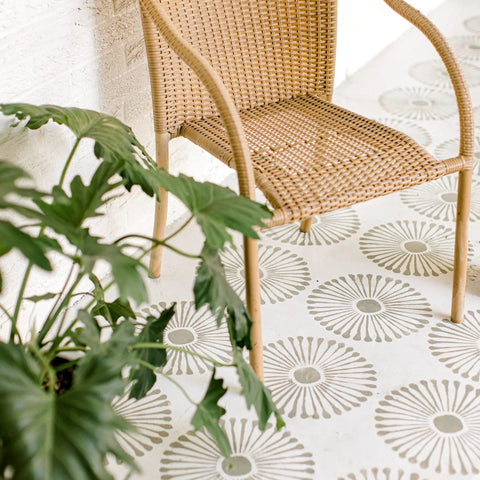 Wicker chair on stenciled floor using Reusable 12x12 Tile Stencil Set 2 Pack For Floors Walls And Concrete, Large Boho Mandala Templates.