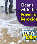 Person using Oxy Solve Concrete And Driveway Pressure Washer Cleaner Purple Unscented 128 Fl Oz Stain Bustin Grime Bustin With Peroxide Power