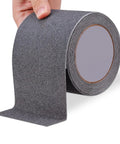 Heavy Duty Non Slip Stair Tape For Indoor And Outdoor Use Waterproof 4 Inch By 33 Feet Tough Traction Grip Roll, shown in hand