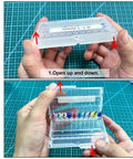 Hands opening a plastic case with 26-piece micro drill bit set 0.1-2.0mm inside, part of Dual-Bearing Pin Vise Hand Drill Kit.