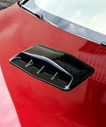 Premium Gloss Black ABS Plastic Hood Scoop Trim Built For Tesla Cybertruck on red car hood, showcasing sleek design and fit.