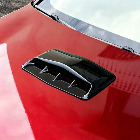 Premium Gloss Black ABS Plastic Hood Scoop Trim Built For Tesla Cybertruck on red car hood, showcasing sleek design and fit.