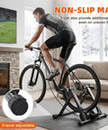 Man using Indoor Magnetic Bike Trainer Stand with Six Level Resistance in living room with front wheel riser block.