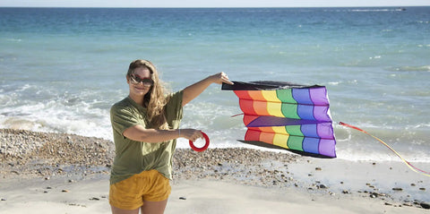 Person holding Rainbow Stripes 5.0 Parafoil Kite For All Ages - Frameless Single-Line Travel Kite on beach, visible rainbow pattern