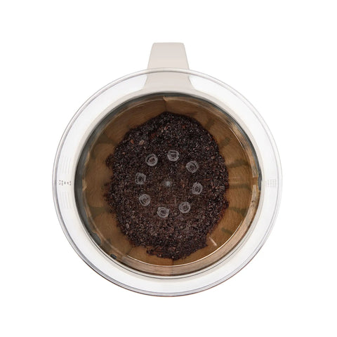 Top view of Single Serve Pour Over Coffee Maker With Auto Drip Tank For A Balanced Brew, showing unbleached filter with coffee grounds.